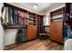 Spacious walk-in closet features custom wood shelving, drawers, and ample storage space for clothes and accessories at 5637 N 78Th Way, Scottsdale, AZ 85250