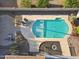 Aerial view of pool with mature desert landscape, firepit, and patio furniture at 5802 E Spring Rd, Scottsdale, AZ 85254