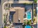 Aerial view of home with pool, firepit, desert landscaping, and lush green trees at 5802 E Spring Rd, Scottsdale, AZ 85254
