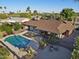 Expansive backyard featuring a pristine pool, fire pit, and seating, perfect for outdoor entertainment and relaxation at 5802 E Spring Rd, Scottsdale, AZ 85254