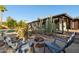 Backyard firepit with chairs surrounded by desert landscape and cacti at 5802 E Spring Rd, Scottsdale, AZ 85254