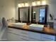 Bright bathroom featuring a double sink, granite countertop, and two framed mirrors at 5802 E Spring Rd, Scottsdale, AZ 85254