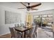 Open dining area features contemporary table set, ceiling fan, stylish decor, and sliding door access to the backyard at 5802 E Spring Rd, Scottsdale, AZ 85254