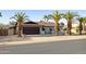 Attractive single-story home with a two-car garage, desert landscaping and mature palm trees at 5802 E Spring Rd, Scottsdale, AZ 85254