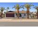 Welcoming single-story home with palm trees, desert landscaping, and a paved driveway to a two-car garage at 5802 E Spring Rd, Scottsdale, AZ 85254