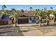 Charming single-story home with desert landscaping, mature palm trees, and a spacious two-car garage at 5802 E Spring Rd, Scottsdale, AZ 85254