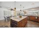 Modern kitchen with a large island, stainless steel appliances, and an adjacent dining area at 5802 E Spring Rd, Scottsdale, AZ 85254