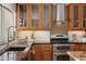Stylish kitchen featuring wood cabinets, modern appliances, and a mosaic backsplash at 5802 E Spring Rd, Scottsdale, AZ 85254