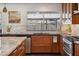 Bright kitchen featuring modern cabinetry, sleek countertops, and a view to the backyard at 5802 E Spring Rd, Scottsdale, AZ 85254
