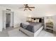 Bedroom with plush bed, side tables, ceiling fan, and ensuite bathroom at 5802 E Spring Rd, Scottsdale, AZ 85254