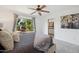 Bedroom features a ceiling fan and sliding door access to the backyard landscaping at 5802 E Spring Rd, Scottsdale, AZ 85254