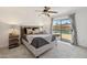 Bedroom features a ceiling fan and sliding door access to the backyard pool area at 5802 E Spring Rd, Scottsdale, AZ 85254