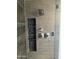 Modern shower featuring elegant grey stone tile and convenient shampoo nook at 5802 E Spring Rd, Scottsdale, AZ 85254