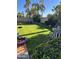 Expansive backyard boasts manicured lawn, mature landscaping, and comfortable seating area for outdoor relaxation at 6819 E Sheena Dr, Scottsdale, AZ 85254