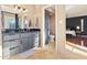 Bathroom with granite countertop, gray cabinetry, and a view to the bedroom and toilet at 6819 E Sheena Dr, Scottsdale, AZ 85254