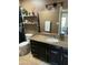 Updated bathroom with a granite countertop, modern lighting, and stylish black accents at 6819 E Sheena Dr, Scottsdale, AZ 85254