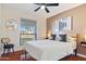 Stylish bedroom featuring hardwood floors, neutral tones, and a ceiling fan for added comfort at 6819 E Sheena Dr, Scottsdale, AZ 85254