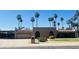 Contemporary home featuring a stucco exterior, tile roof, and desert landscaping with mature palm trees at 6819 E Sheena Dr, Scottsdale, AZ 85254
