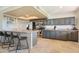 Modern kitchen with stainless steel appliances, stone countertops and a breakfast bar with stools at 6819 E Sheena Dr, Scottsdale, AZ 85254