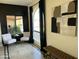 Bright sitting area with neutral furniture, black accent wall, and view to the exterior at 6819 E Sheena Dr, Scottsdale, AZ 85254