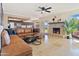 Spacious living room with a stone fireplace and light-filled views of the exterior at 6819 E Sheena Dr, Scottsdale, AZ 85254
