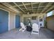 Outdoor seating area beneath a covered patio overlooking a backyard with a storage shed and wood fence at 8135 N Central Ave # 1, Phoenix, AZ 85020