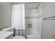 This bathroom features a white shower curtain, tiled shower surround, and a modern toilet and vanity at 8135 N Central Ave # 1, Phoenix, AZ 85020