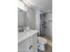 This bright bathroom features a walk-in shower with tile surround, a speckled vanity top, and a modern sink at 8135 N Central Ave # 1, Phoenix, AZ 85020