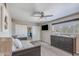 A spacious bedroom with two closets, a dresser, a ceiling fan, and a large window for plenty of natural light at 8135 N Central Ave # 1, Phoenix, AZ 85020