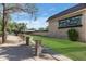 The front of this brick apartment complex features a well-manicured lawn, a sidewalk, and mature trees at 8135 N Central Ave # 1, Phoenix, AZ 85020