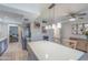A full view of the kitchen including an island, stainless steel appliances, quartz countertops, and modern light fixtures at 8135 N Central Ave # 1, Phoenix, AZ 85020