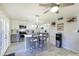 An island kitchen featuring stainless steel appliances, white cabinets, bar seating, and seamless flow to the dining area at 8135 N Central Ave # 1, Phoenix, AZ 85020