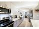 Bright, remodeled kitchen featuring stainless steel appliances, quartz countertops, and modern white and gray cabinets at 8135 N Central Ave # 1, Phoenix, AZ 85020