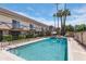 Sparkling community pool with lounge chairs, mature landscaping, and blue skies at 8135 N Central Ave # 1, Phoenix, AZ 85020