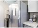 Stainless steel refrigerator with a drink station alongside white kitchen cabinets and a mixer on the counter at 8135 N Central Ave # 1, Phoenix, AZ 85020