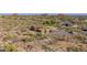 Desert home with multiple garages, and a pool area surrounded by arid vegetation, offering privacy and scenic views at 8752 E Range Rider Trl, Mesa, AZ 85207