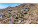 Estate with a pool and desert landscaping, featuring native vegetation, offering seclusion and views of the surrounding mountains at 8752 E Range Rider Trl, Mesa, AZ 85207