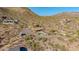 Remote desert property featuring a pool, patio, and a home surrounded by native vegetation, offering privacy and views at 8752 E Range Rider Trl, Mesa, AZ 85207