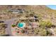 Aerial view of a private desert estate featuring a pool, mature landscaping, surrounded by mountain views at 8752 E Range Rider Trl, Mesa, AZ 85207