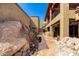 Backyard view showcasing large boulders and unique architecture, providing privacy and natural beauty at 8752 E Range Rider Trl, Mesa, AZ 85207
