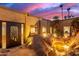 Backyard oasis at dusk features a unique rock fountain and desert landscaping at 8752 E Range Rider Trl, Mesa, AZ 85207