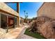 Landscaped backyard featuring unique desert flora and towering palm trees providing a serene outdoor space at 8752 E Range Rider Trl, Mesa, AZ 85207