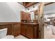 Bathroom featuring wood paneling, a sink, wooden vanity and an adjacent toilet at 8752 E Range Rider Trl, Mesa, AZ 85207