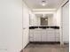Bright bathroom featuring double sinks and a large mirror at 8752 E Range Rider Trl, Mesa, AZ 85207