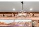 Dining room featuring a unique chandelier, display shelf, and desert-themed artwork at 8752 E Range Rider Trl, Mesa, AZ 85207