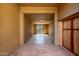 Neutral tones create a sense of calm in this empty room with concrete floors and a view through the door at 8752 E Range Rider Trl, Mesa, AZ 85207