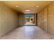An empty room has earth-toned walls, a concrete floor and a view to the outdoors at 8752 E Range Rider Trl, Mesa, AZ 85207