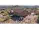 Desert property featuring a home with a red tile roof, stucco walls, and a desert landscape surroundings at 8752 E Range Rider Trl, Mesa, AZ 85207