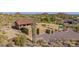 Expansive desert property featuring a multi-structure home with multiple garages, a red tile roof, and xeriscaping at 8752 E Range Rider Trl, Mesa, AZ 85207