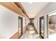 Bright hallway with display shelves, seating, and multiple doorways and windows at 8752 E Range Rider Trl, Mesa, AZ 85207